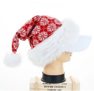 Detail of knitted Christmas hat with snowflake pattern, plush pompom and baseball cap brim