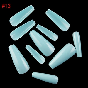 Flat lay detail of light blue coffin press-on nails in various sizes on black background