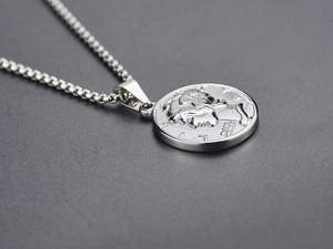 Macro view of silver coin pendant with Liberty relief and durable square box chain