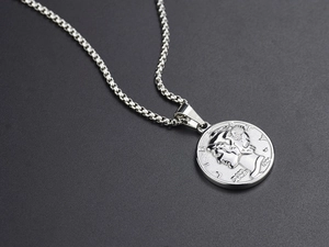 Close-up of silver titanium steel necklace featuring a relief coin pendant with winged portrait