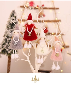 Detail of plush Christmas angel ornaments with sequin wings on white branches