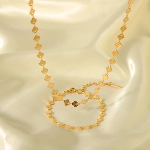 Elegant 18K gold plated stainless steel shell necklace and bracelet set on beige silk