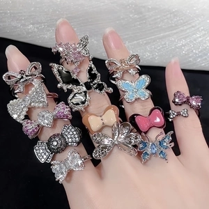 Set of 13 butterfly and bow rings with sparkling zircons and colorful enamel details