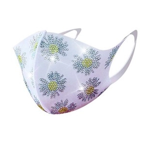 Close-up of stylish white fashion mask featuring sparkly rhinestone daisy floral patterns