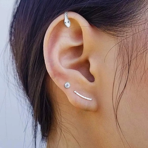 Detailed view of S925 silver snake crawler earring set with stones on model's ear