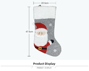 Detail of Christmas stocking with Santa Claus applique and snowflake embroidery on felt