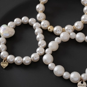 Three-piece pearl bracelet hair ties with gold charms and colorful heart pendant