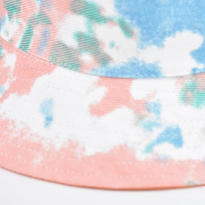 Close-up of high-density cotton twill fabric with colorful tie-dye patterns and stitching