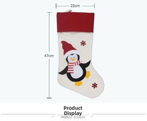 Detailed view of large Christmas stocking featuring cute penguin print and size dimensions