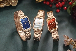 Close-up of vintage square women's watches with blue, pearl, and brown dials on metal straps