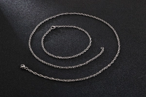 Detailed view of silver stainless steel twisted rope chain necklace and bracelet set