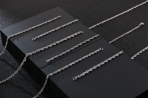 Detailed view of multiple silver stainless steel twisted link chains on display