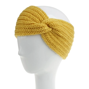 Detail view of yellow knitted cross knot headband on a model against white background