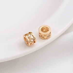 Macro shot of 14K gold plated lattice spacer beads with micro-set cubic zirconia accents