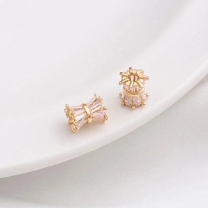 Close-up of 14K gold plated gear-shaped spacer beads with cubic zirconia for DIY jewelry