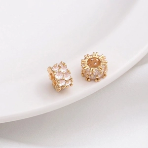 Macro detail of 14K gold-plated wheel spacers with micro-set cubic zirconia stones