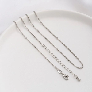 Detail of silver beaded chain with lobster clasp, adjustable extender and water drop pendant