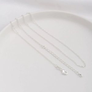 Detail of 14K gold plated necklace with lobster clasp, extender chain and teardrop pendant