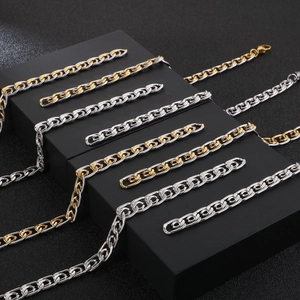 Two-tone 8mm stainless steel chain necklace and bracelet set on black display stands
