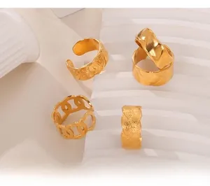 Detail of vintage gold textured open rings showing embossed scrolls and woven metal patterns