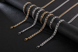 Close-up of 8mm gold and silver stainless steel curb chain sets on black display stand