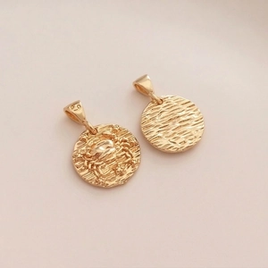 Macro view of 14K gold-plated Cancer zodiac pendant showing crab relief and textured back