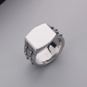 Detail view of vintage silver square signet ring with side stud texture for men