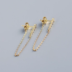 Detailed macro view of S925 sterling silver hallmark on gold-plated long tassel earrings