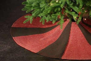 Detail of red and black striped knitted Christmas tree skirt with woven texture
