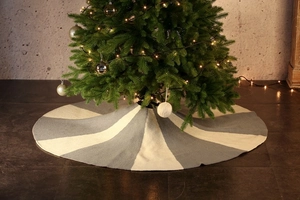 Close-up of a 48-inch gray and white knitted Christmas tree skirt with stripe pattern