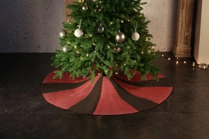 Close-up of knit Christmas tree skirt with classic red and black radial striped pattern