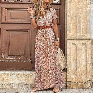 Detail of bohemian V-neck floral maxi dress with brown leather belt and white fabric
