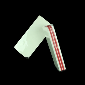 Detail of thickened nail buffer block with dual red foam layers on black background