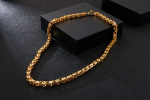 Detailed view of golden stainless steel flower link chain necklace with lobster clasp