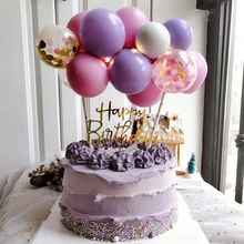 Cake topper detail featuring Happy Birthday sign and purple pink balloon cluster decor