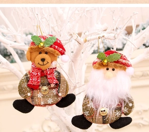 Detail of fabric Christmas bear and Santa hanging ornaments with red plaid and metal bells