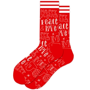 Detail of red Christmas socks featuring Happy Xmas and peace and love festive text patterns