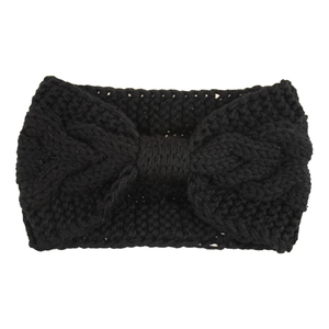 Detail showing the chunky cable knit texture and twisted knot of this black winter headband