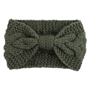 Detailed close-up of dark green cable knit headband with a textured bow design