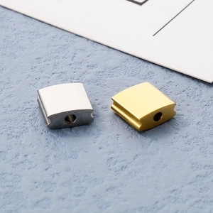 Macro view of gold and silver square stainless steel spacer beads for DIY jewelry