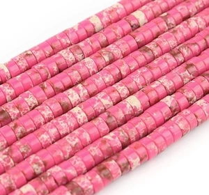 Macro detail of flat cylindrical rose pink stone spacer beads for DIY jewelry making