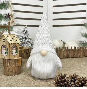 Detail of white and silver sequined Christmas gnome with festive winter forest decor