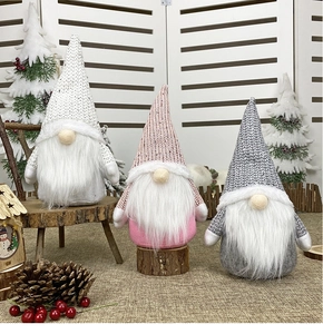 Three festive Christmas gnomes in white, pink, and grey with knitted hats and fur beards