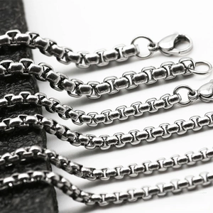 Macro detail of silver stainless steel box chains with secure lobster clasps and polished finish