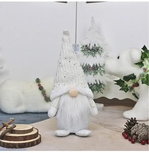 Detail of white sequined Christmas gnome with plush beard and festive winter decor