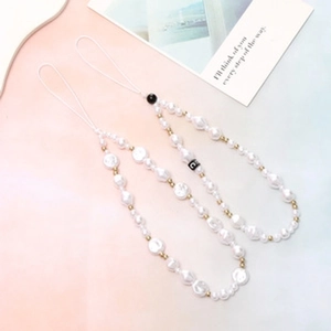 Close-up of baroque pearl beaded phone charms with gold accents and white string ties