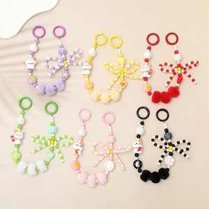 Detail view of colorful acrylic beaded chains with plush balls and cartoon cat charms