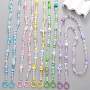 Detailed view of colorful beaded phone lanyards with star and flower charms on grey background