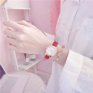 Women's quartz watch with red leather strap and heart moon bracelet set in soft light
