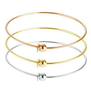 Detailed macro view of minimalist three-color polished stainless steel bangles set